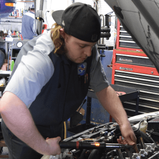 Evan repairing an engine  in Plymouth Wisconsin