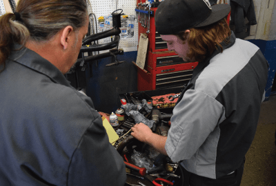 Our auto repair service in Plymouth and Sheboygan County Wisconsin employees working on an engine